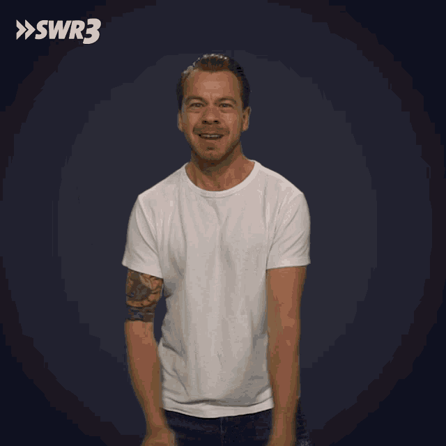 a man in a white shirt is making a funny face in front of a blue background with the swr3 logo