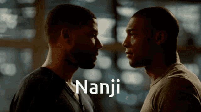 two men are looking at each other and the word nanji is visible