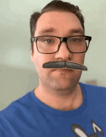 a man wearing glasses has a fake mustache that says screaming veteran