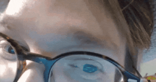 a close up of a person 's face with glasses