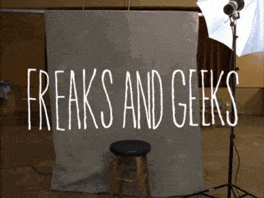 a sign that says freaks and geeks in white letters