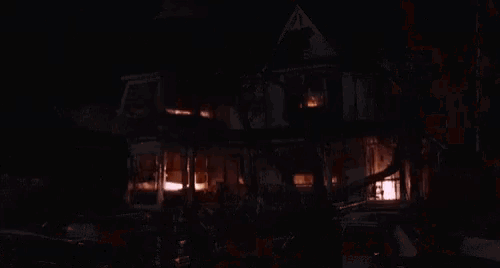 a house is on fire at night with smoke coming out of the chimney .