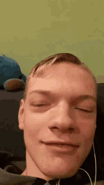 a close up of a man 's face with headphones on