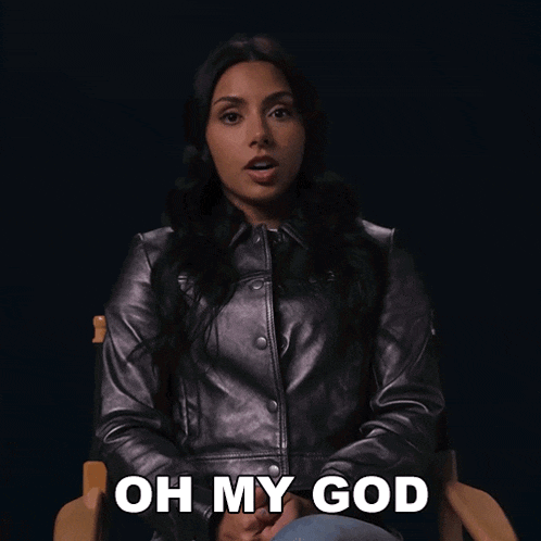 a woman in a leather jacket is sitting in a chair saying oh my god