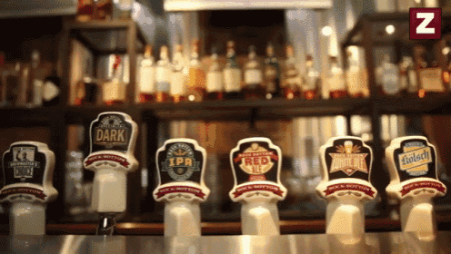 a row of beer taps including one called dark