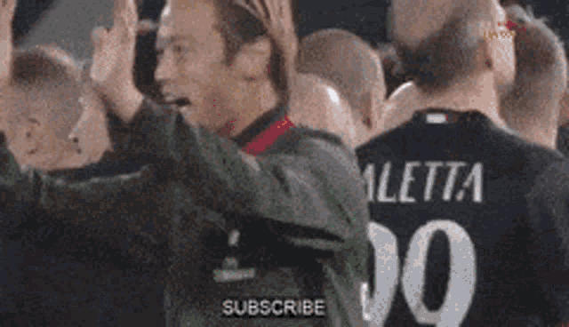 a soccer player wearing a number 10 jersey is giving a high five