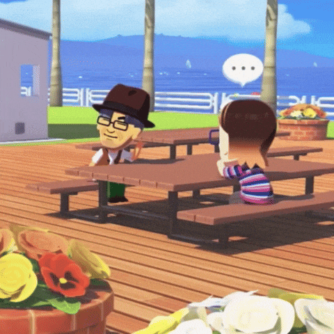 a man and a girl are sitting at picnic tables on a deck