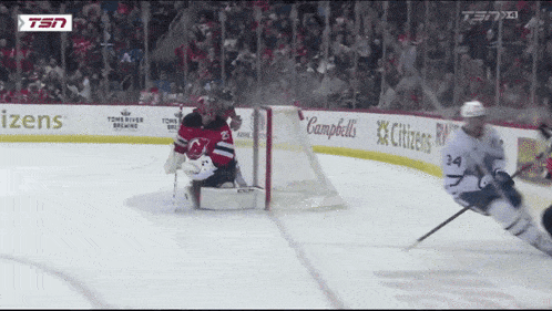 a hockey game is being played in front of a citizen advertisement
