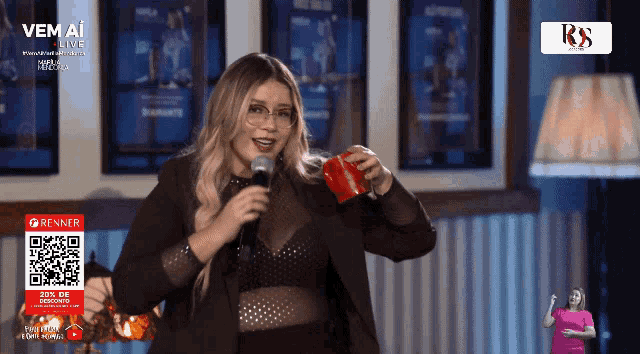 a woman singing into a microphone in front of a sign that says vem a live