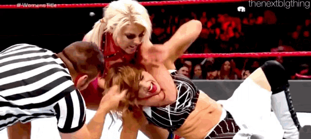 two women are wrestling in a ring with a referee and the nextbigthing written on the bottom