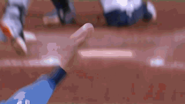 a baseball player is trying to catch a ball on a field