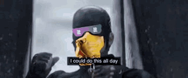 a man wearing a mask and goggles is standing in front of a window and talking .