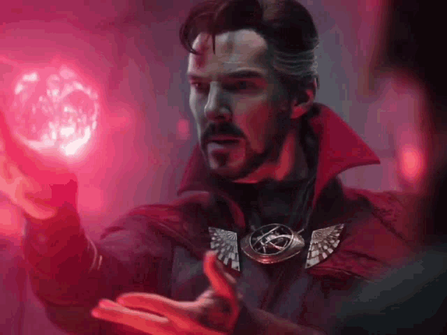 a man in a red coat is holding a red ball in his hand