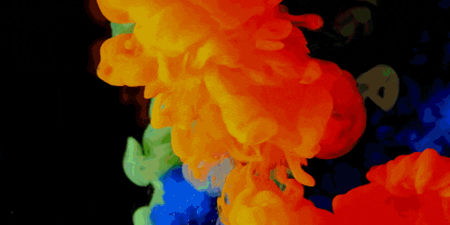 orange blue and green smoke against a black background with the letter a visible
