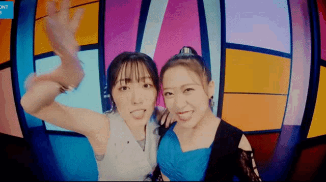 two women are posing for a picture in front of a stained glass window with the word onit on the bottom