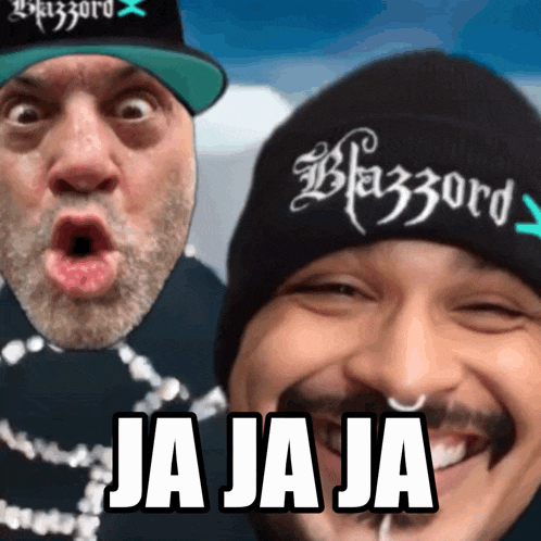 a man wearing a beanie that says blazzard is smiling next to another man