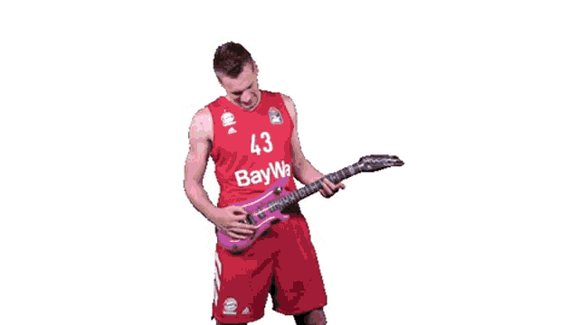 a man wearing a red jersey with the number 43 on it is playing a guitar