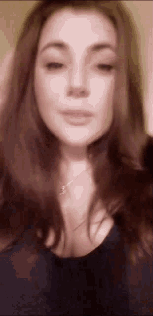 a close up of a woman 's face with a necklace on