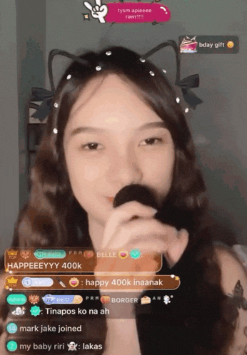 a girl singing into a microphone with the words happy 400k inaanak at the top