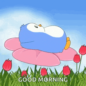 a penguin is sleeping on top of a pink flower in a field of flowers .