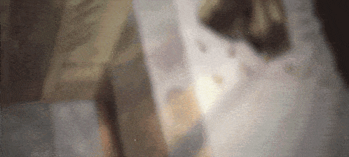 a blurry picture of a person standing in front of a wall