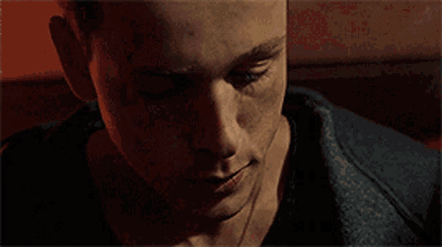 a close up of a man 's face in a dark room .