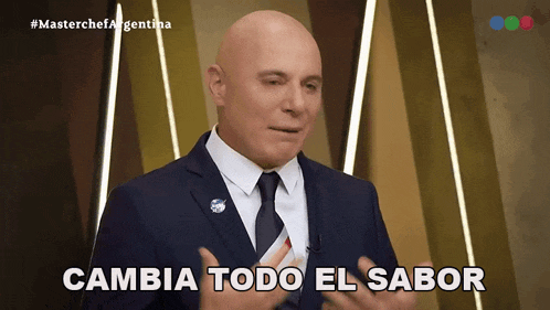 a bald man in a suit and tie says " cambia todo el sabor "