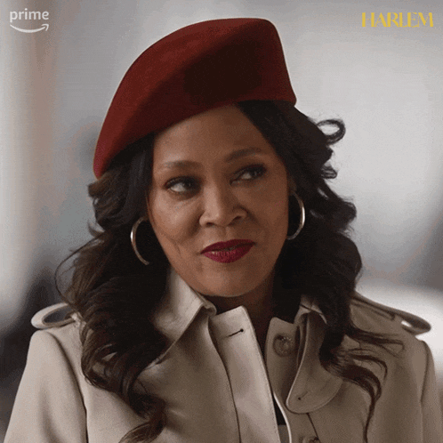 a woman wearing a red beret and hoop earrings is featured on a prime ad