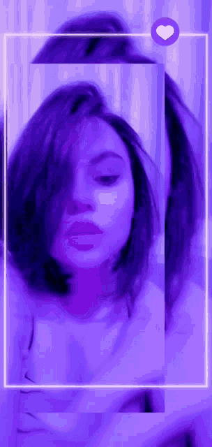 a blurry picture of a woman in a purple frame with a heart in the corner