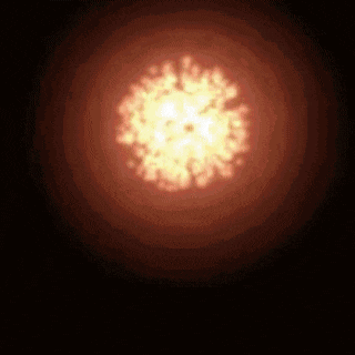 a close up of a fireball in the dark with a black background .
