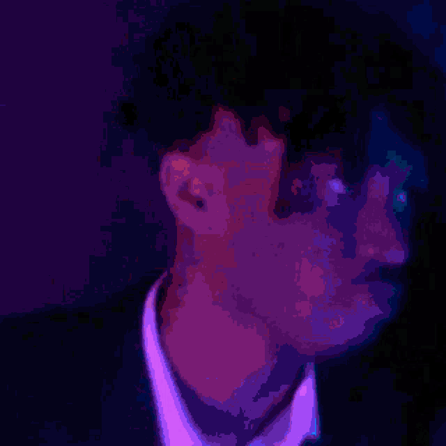 a close up of a man 's face in a dark room