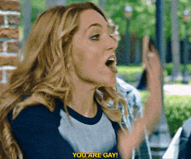 a woman in a baseball shirt says you are gay in front of a brick wall