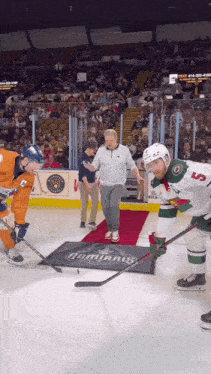 a hockey player wearing number 5 is standing on the ice