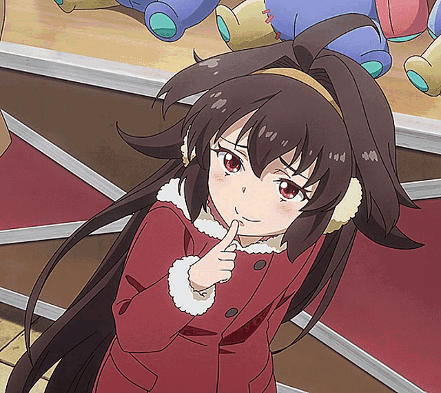 a girl with long brown hair is wearing ear muffs