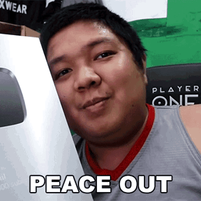 a man holding a box that says peace out on it