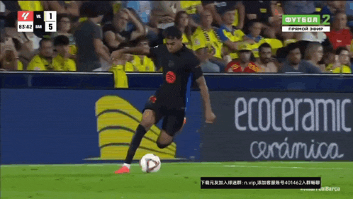 a soccer player kicking a ball in front of an ecoceramic ad