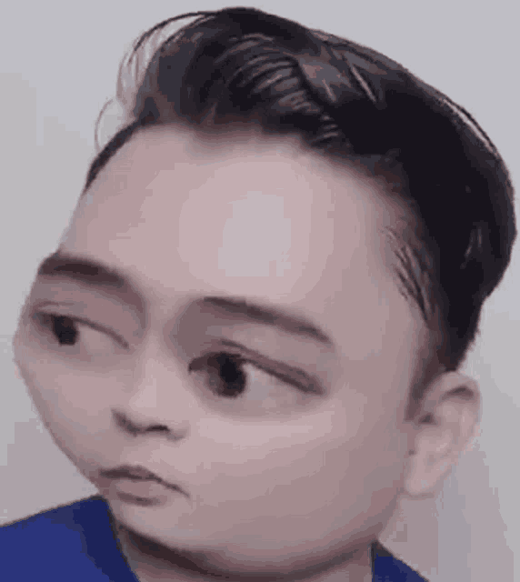 a close up of a man 's face with a very big head .