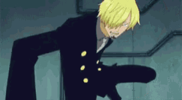 a man with blonde hair and a black suit is standing in a dark room holding a gun .