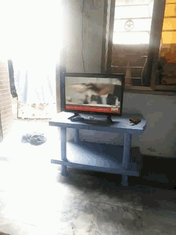a tv hanging on a wall with a foreign language advertisement on it