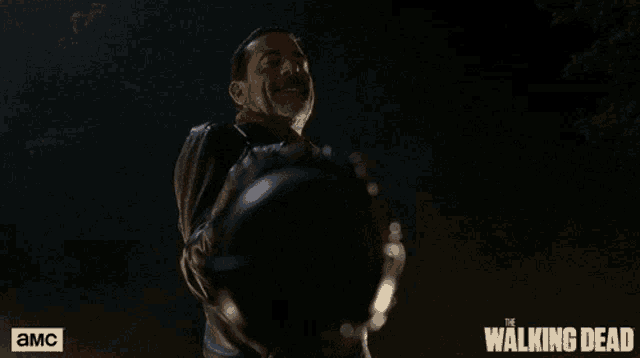 an advertisement for the walking dead shows a man holding a sword