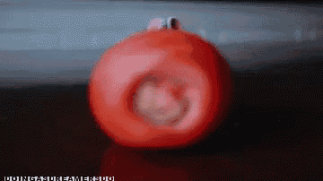 a red ball with a face on it is sitting on a table with the words " doing a dream " below it