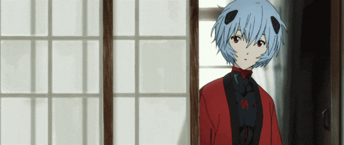a girl with blue hair is standing in front of a window .