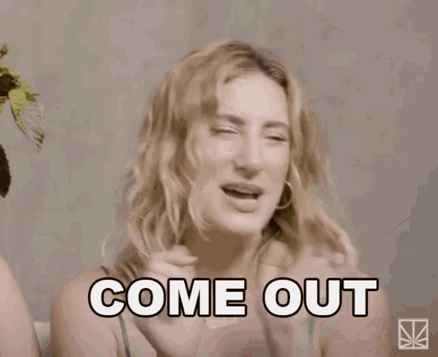 a woman says " of the closet " with her hands in the air