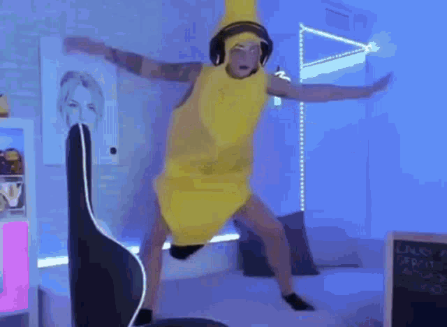 a man wearing headphones and a banana costume is dancing on a bed .