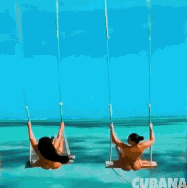 two women are swinging in the ocean with the word cubana in the bottom right corner