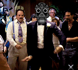 a man with a skull mask on his face stands in a crowd of people