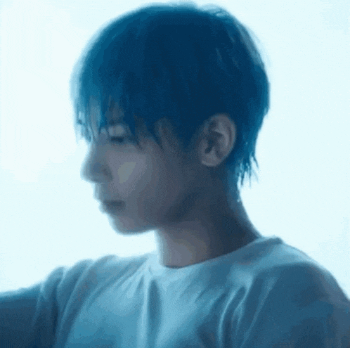 a close up of a person 's face with a blue background .