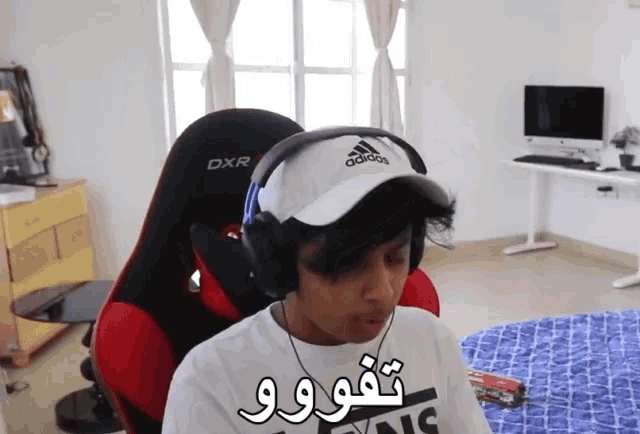 a person wearing headphones and a hat that says adidas on it