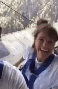 a woman is laughing while riding a slingshot ride .