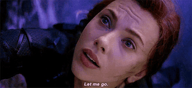 a close up of a woman 's face with the words `` let me go '' .